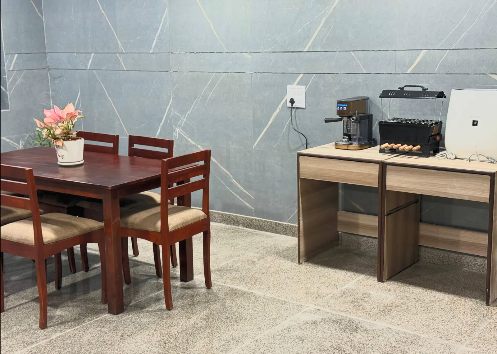 Shared dining table beside a counter with resident kitchen appliances.