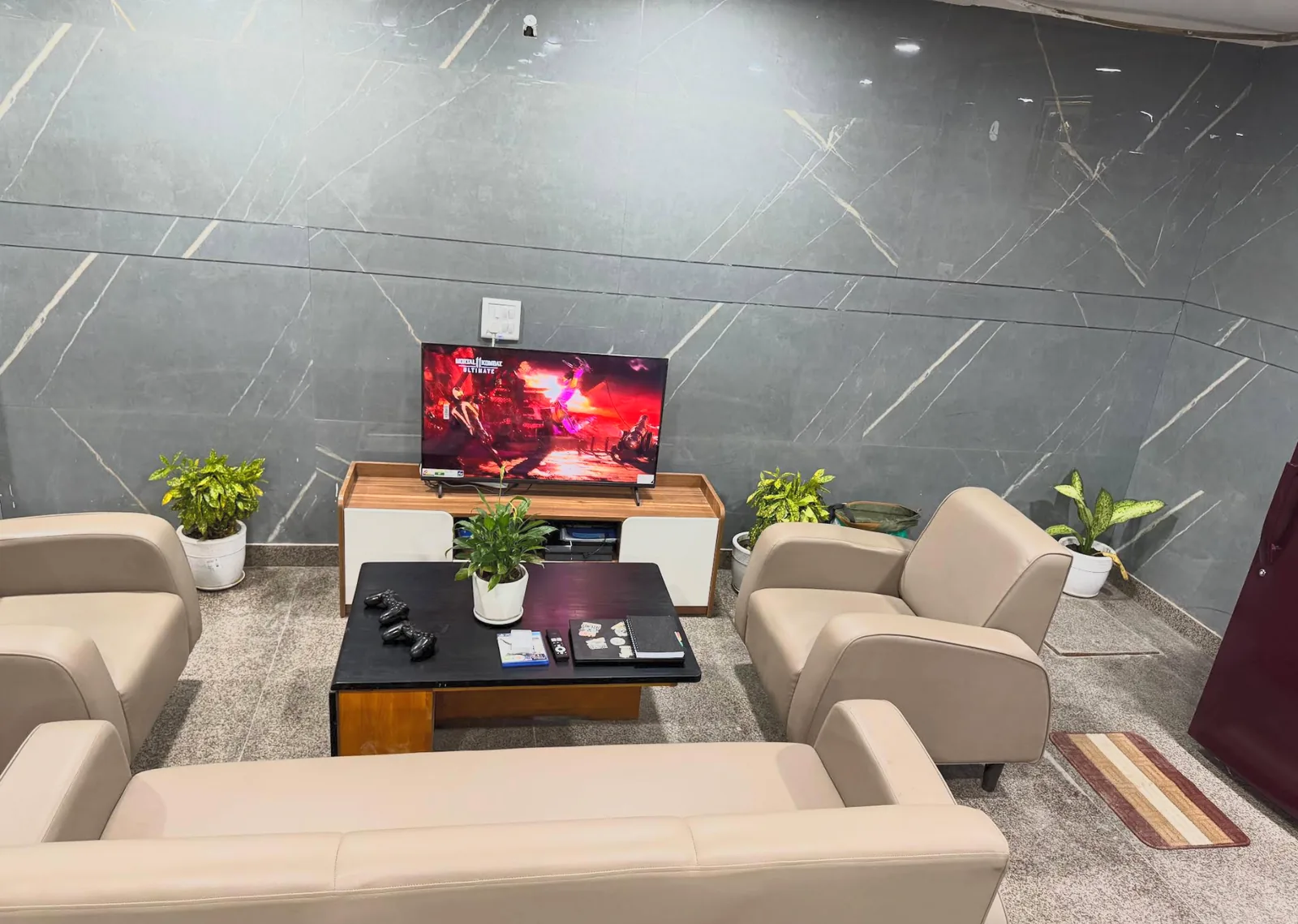 Common lounge arranged around a television with sofas and armchairs.